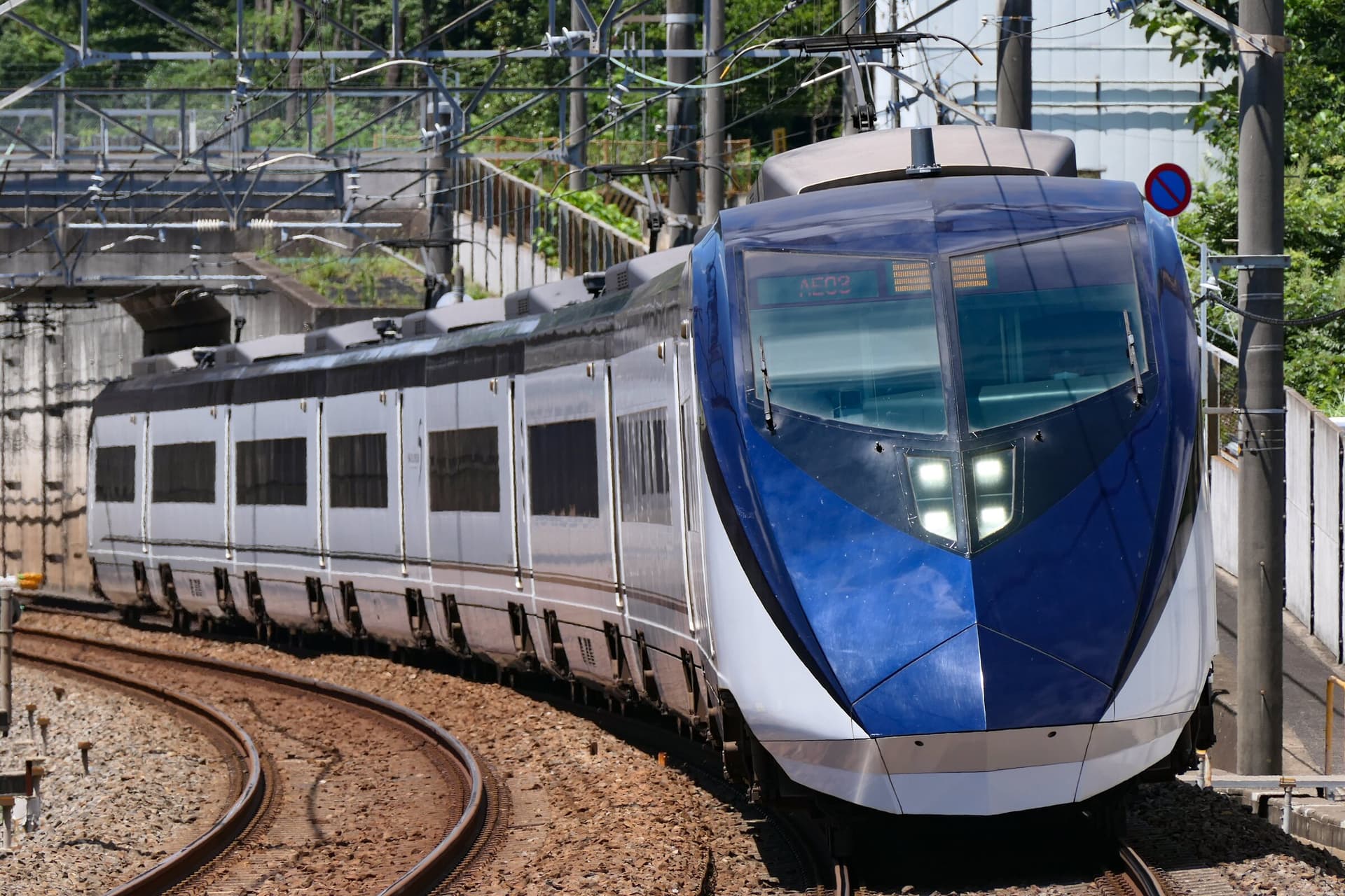 The blue-and-white Keisei Skyliner approaching a station