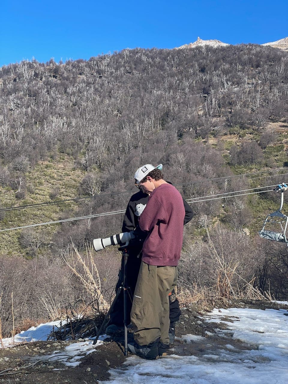 Creators setting up a camera on a snowy Bariloche mountainside