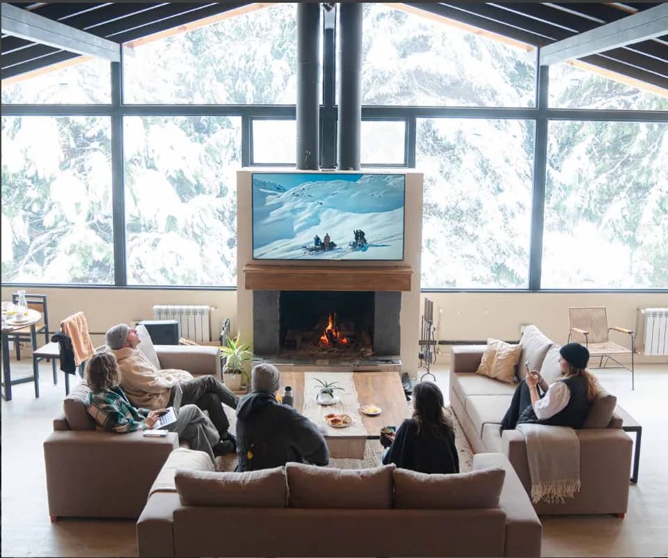 The Premium House living room with warm wood interiors and mountain views